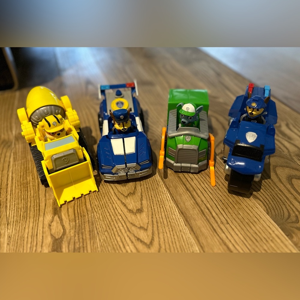 Four Paw Patrol vehicles with their pups